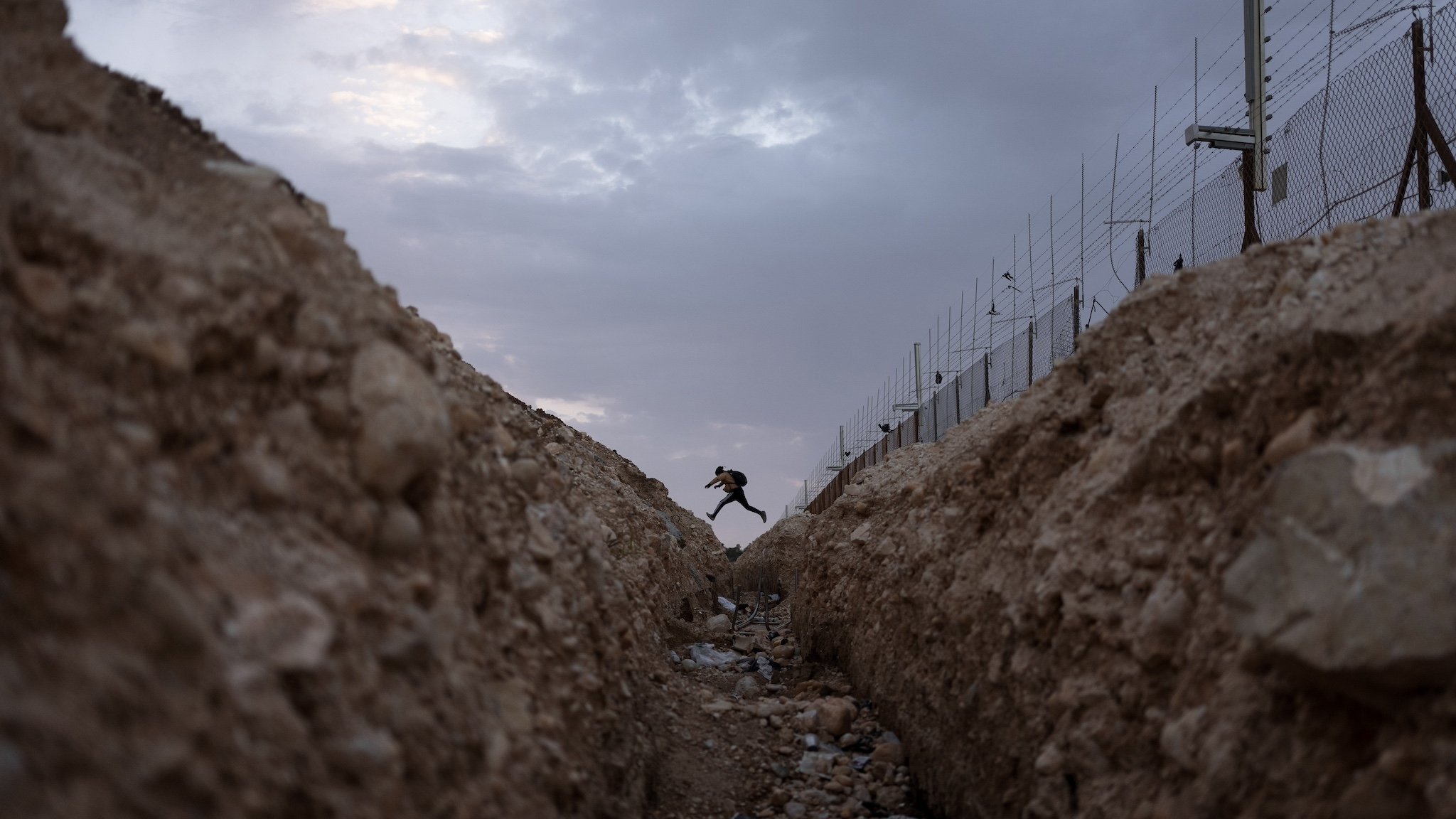 A Palestinian crosses into Israel from the West Bank through an opening in the Israeli separation barrier near Meitar crossing.