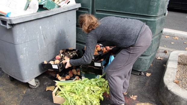 Frau durchsucht Müll nach Essen (Symbolbild)