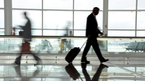 Personen laufen durch eine Halle in einem Flughafen