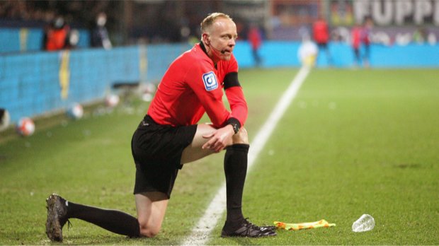 BOCHUM, Germany - 18. March 2022: Christian Gittelmann, referee assitant and a cup of beer on the ground during the Bundesliga Football match between VfL Bochum and Borussia Moenchengladbach at the Vonovia Ruhrstadion in Bochum on 18. March, 2022 Germany.