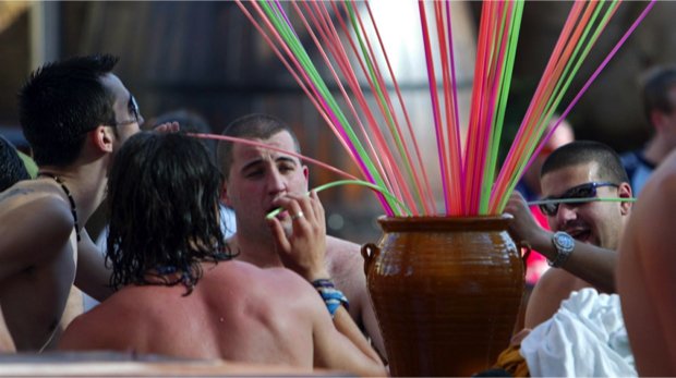 Menschen trinken Sangria mit Strohhalmen aus einem Eimer auf Mallorca