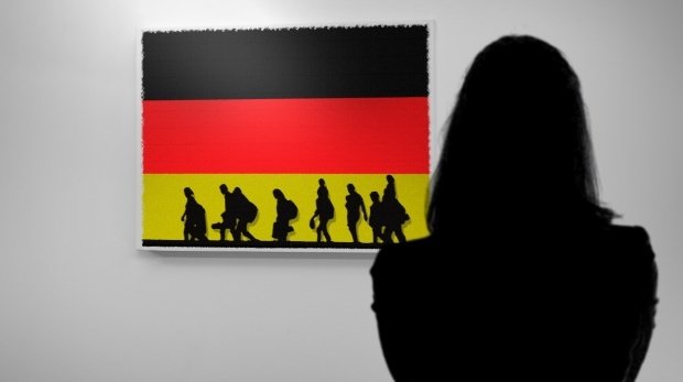 Deutschlandfahne und Silhouetten von Flüchtlingen