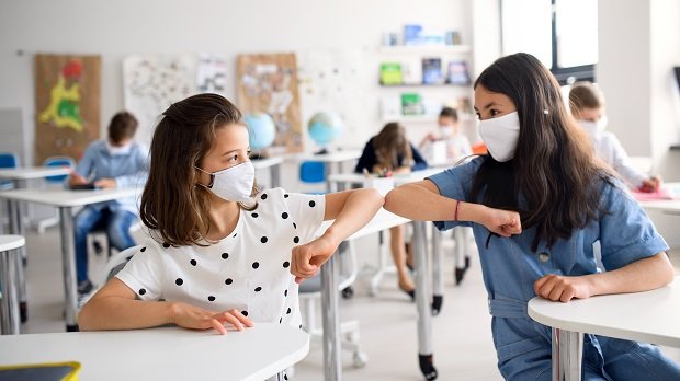 Schülerinnen mit Maske im Klassenzimmer
