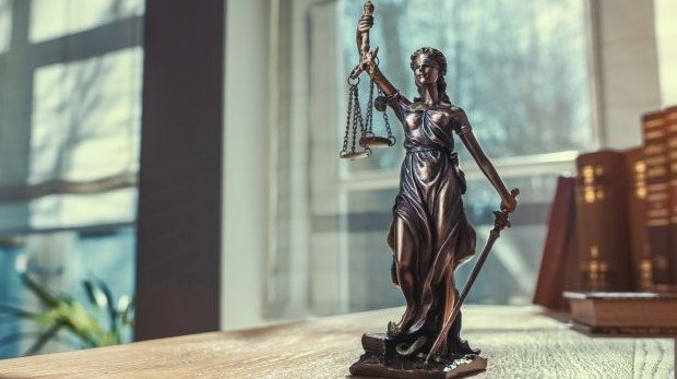 Figur der Justizia auf einem Schreibtisch