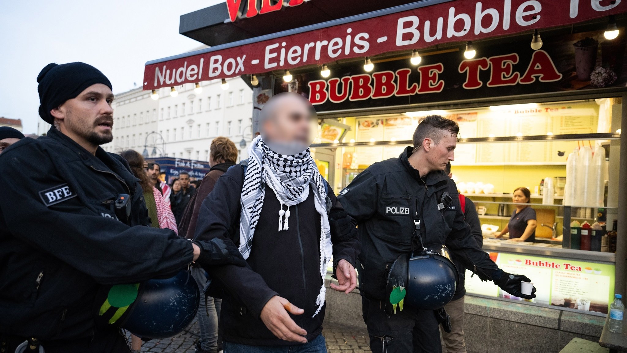 Polizeibeamte nehmen auf dem Berliner Hermannplatz einen Demonstranten fest