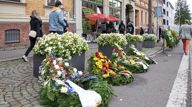 Einem Jahr nach dem Attentat liegen Kränze vor dem Döner-Imbiss in Halle, in dem ein junger Mann ermordet wurde.