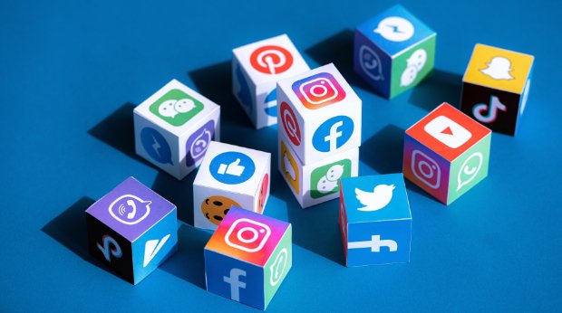 Papierwürfel mit Logos und Symbolen verschiedener Social Media Plattformen