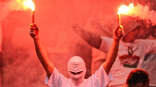 Ein Fußballfan brennt Pyrotechnik ab